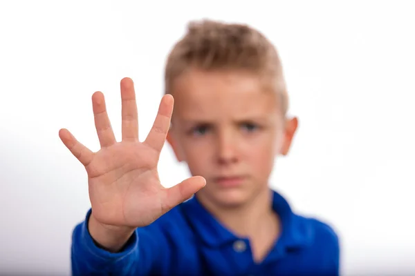 Boy with raised hand making stop gesture — Stock Photo, Image