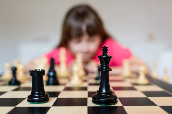 Girl and chess pieces — Stock Photo, Image