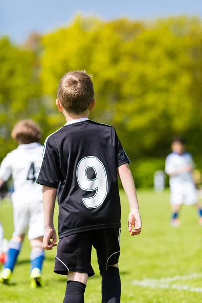 Ung pojke tittar på en barn fotboll matchar — Stockfoto