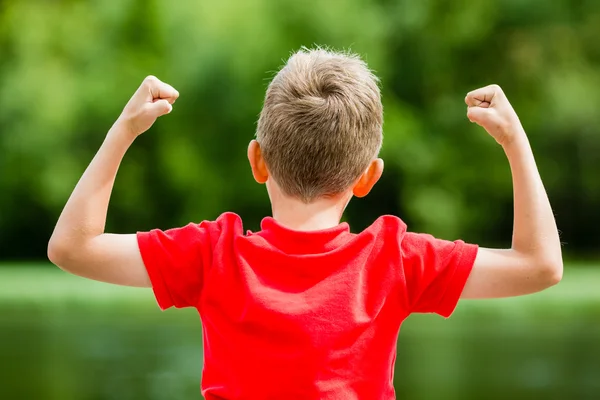 Back of child with fists in the air — Stock Photo, Image