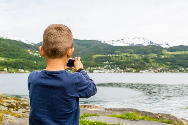 Pojke med bild med digital kompakt kamera — Stockfoto