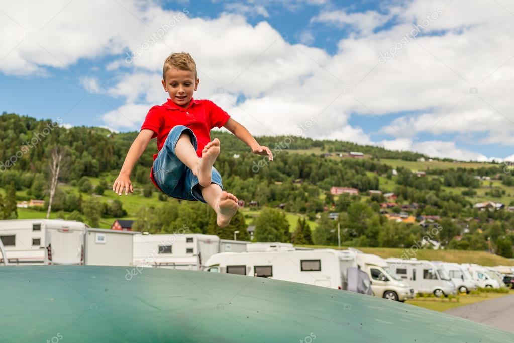 Young boy jumping on trampoline