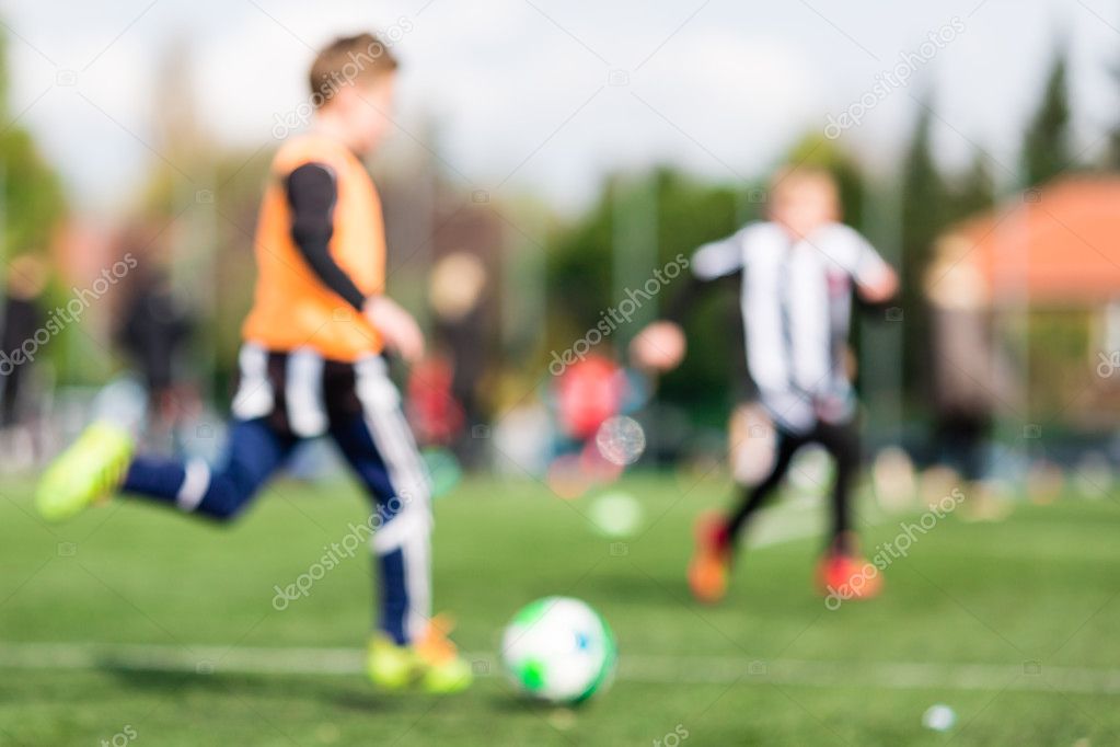 Blur of young boys playing soccer match