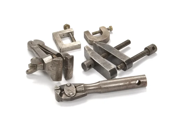 Old screw clamps on a light background — Stock Photo, Image