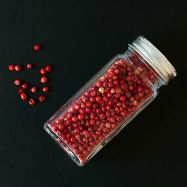Spices Pink Peppers Transparent Jar Black Background Shallow Depth Field — Stock Photo, Image