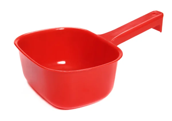 Plastic ladle of red on a white background — Stock Photo, Image