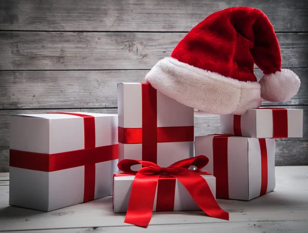 Stack of white Christmas gift, with santa claus hat — Stock Photo, Image