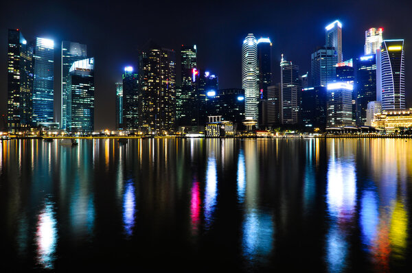 Business district skyline by night in Singapore, one of East Asias fastest financially growing