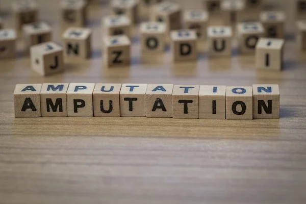 Amputation written in wooden cubes — Stock Photo, Image