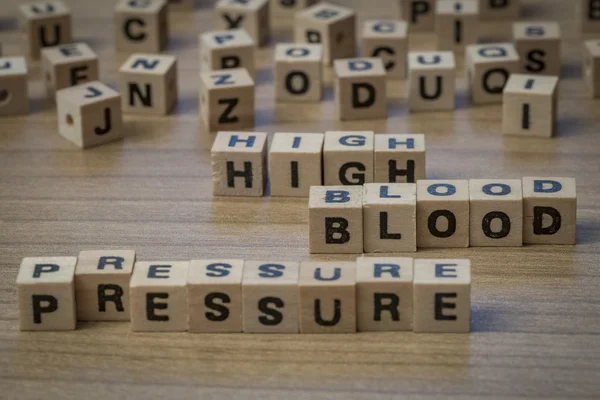 High blood pressure written in wooden cubes — Stock Photo, Image