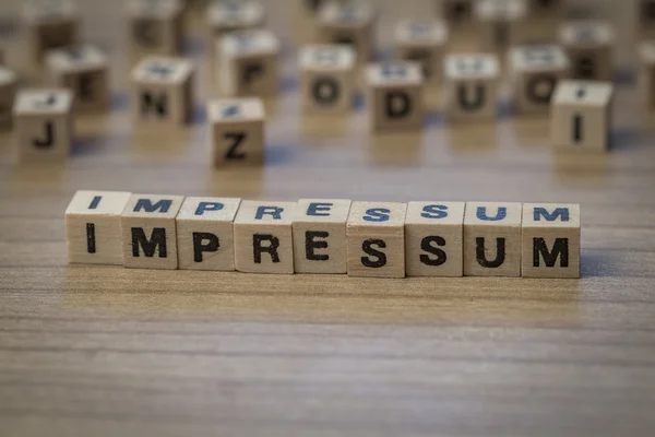 Impressum written in wooden cubes — Stock Photo, Image