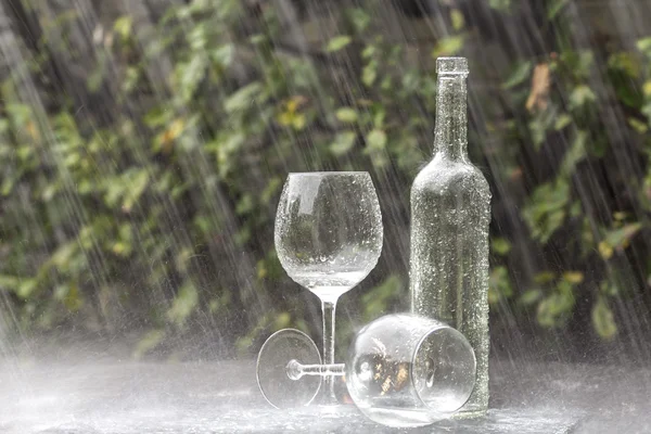 Wine Bottle and Glasses in Summer rain — Stock Photo, Image