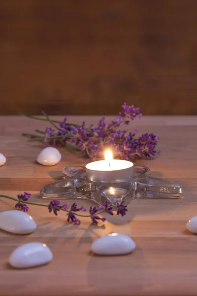 Vela e lavanda em fundo de madeira — Fotografia de Stock