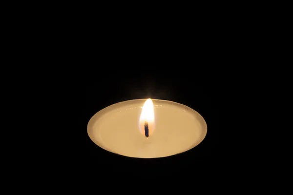 Single Tea Candle on Black — Stock Photo, Image