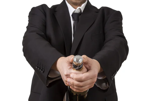 Man in siut opening Champagne bottle — Stock Photo, Image