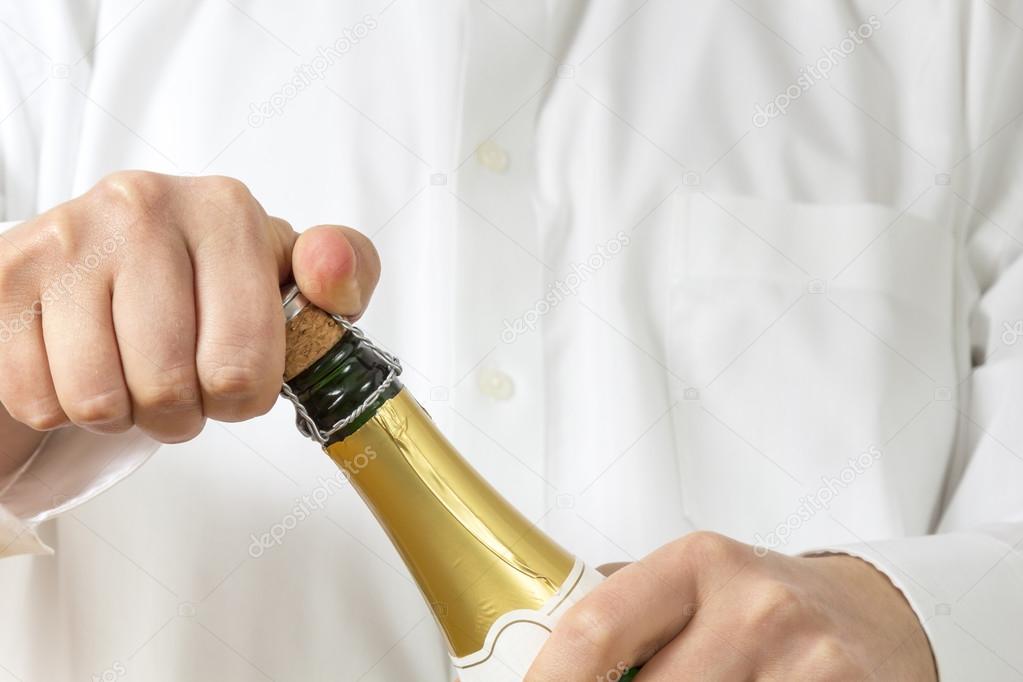 Waiter opening a botle of Champagne