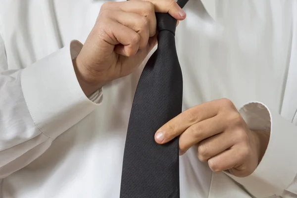 Man in shirt straightening his tie — Stock Photo, Image