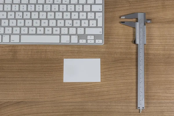 Keyboard and a sliding caliper on Desktop — Stock Photo, Image