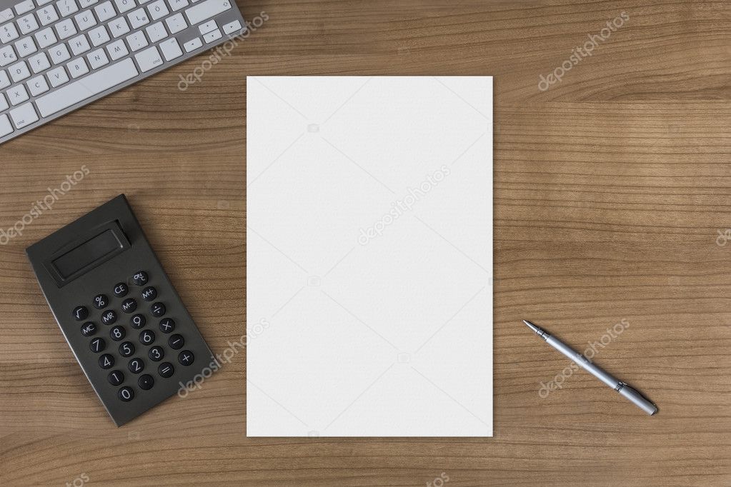 Blank sheet on a wooden table with calculator