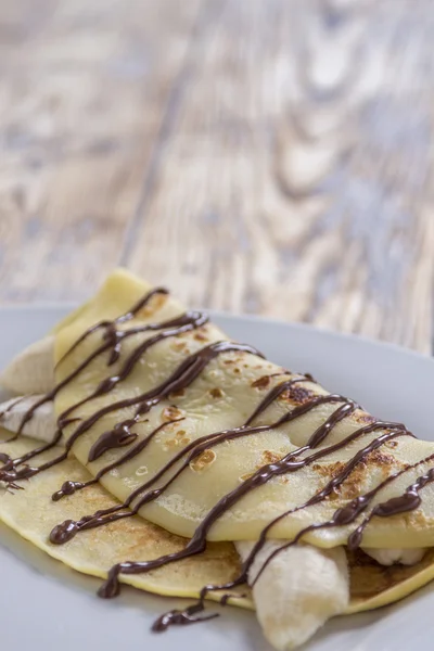 Crepe with banana and chocolate sauce — Stock Photo, Image