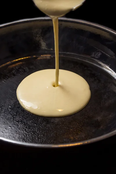 Pancake batters pouring in pan — Stock Photo, Image