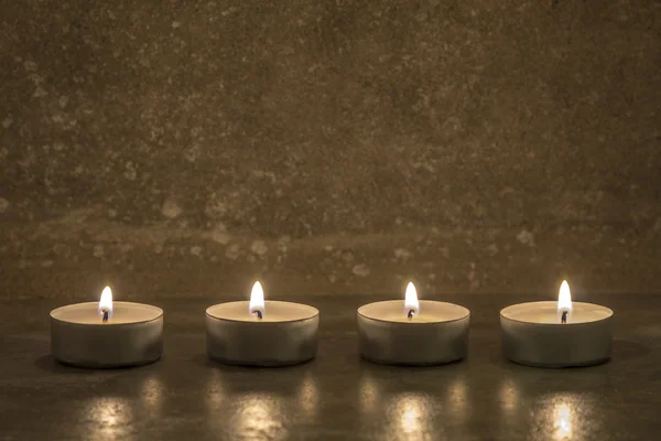 Tea candles on concrete — Stock Photo, Image