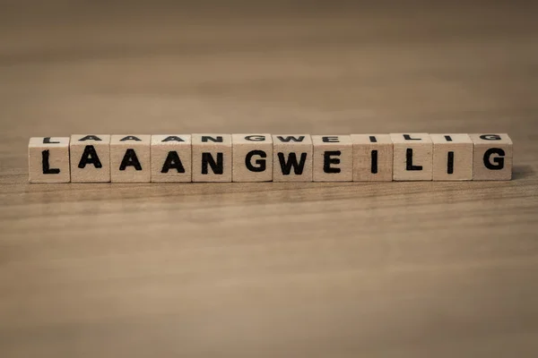 Laaaangweilig in wooden cubes — Stock Photo, Image