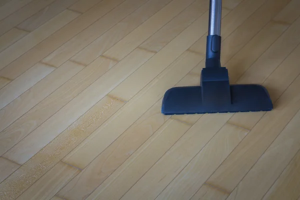 Vacuum cleaner on wooden floor — Stock Photo, Image