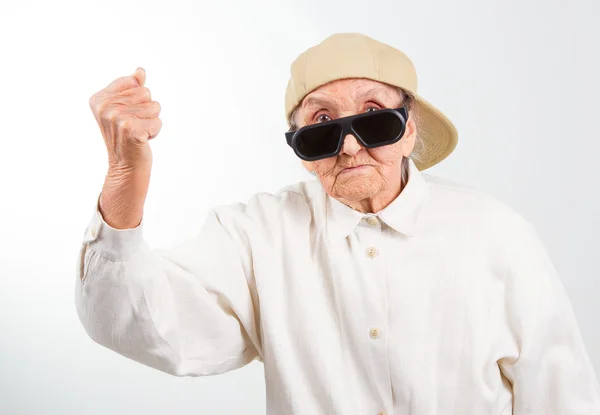 Cool grandma kicks with her fist — Stock Photo, Image