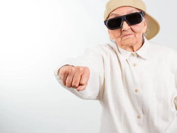 Cool grandma kicks with her fist — Stock Photo, Image