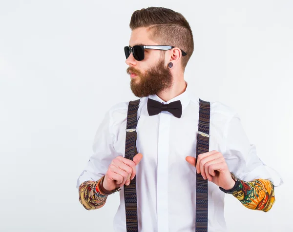 Portrait of a stylish hipster holding his suspenders — Stock Photo, Image