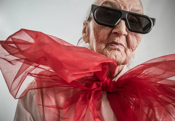 Molto vecchia signora con un fiocco rosso — Foto Stock