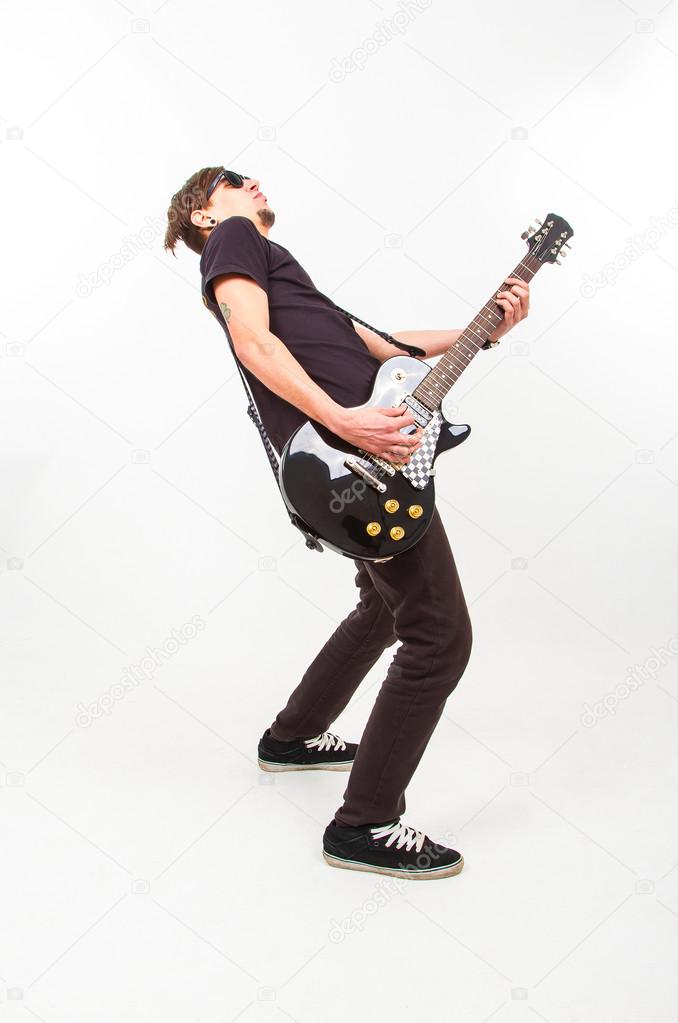 young rockstar playing on guitar 