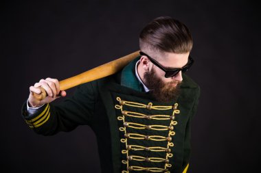 Uniform, sunglasses and a bat