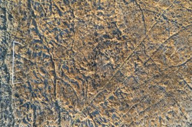 drone view of an one old natural football filed with long dry grass