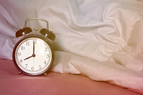 Alarm Clock on The Bed — Stock Photo, Image