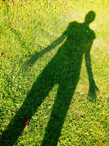Person shadow on the grass — Stock Photo, Image