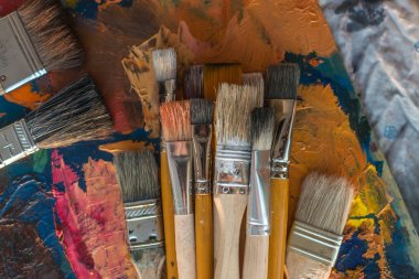 Paintbrush collection on old palette 
