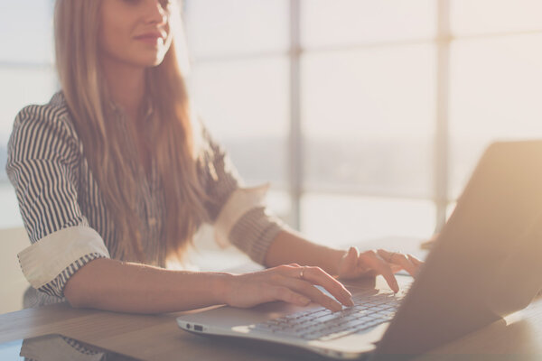 Female writer typing using laptop  