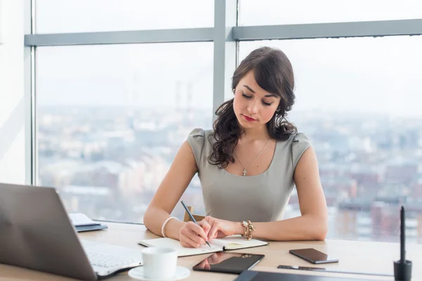 Young female clerk sitting — Stock Photo, Image