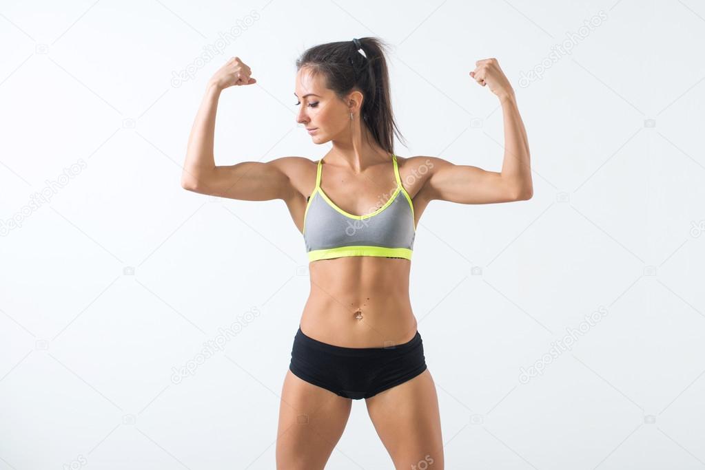 Fit woman showing biceps Stock Photo by ©undrey 116513030