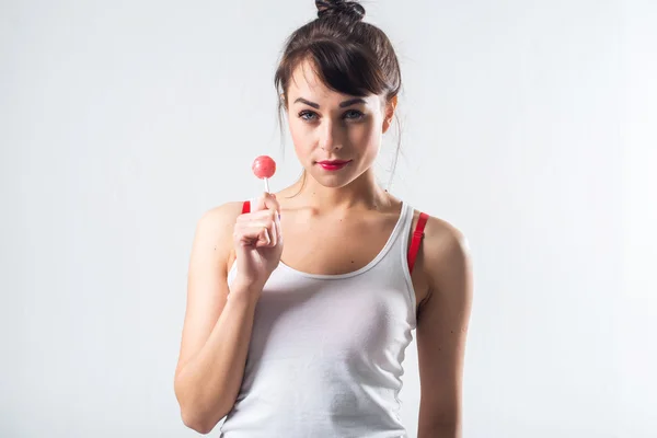 Young brunette model with lollipop — Stock Photo, Image