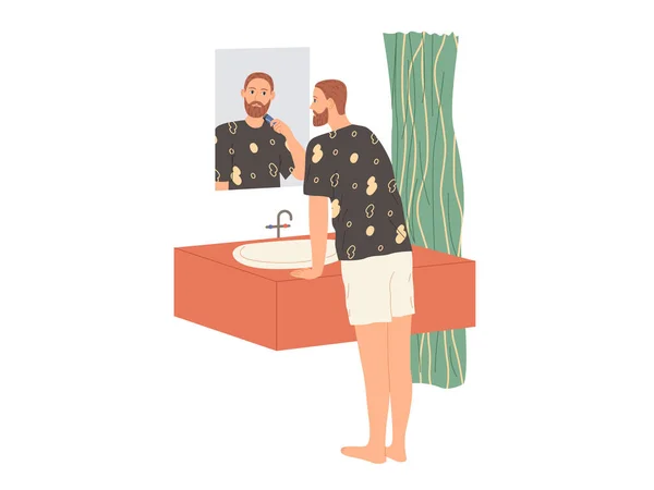 L'homme se rase la barbe avec un rasoir électrique tout en se tenant dans la baignoire près du miroir — Image vectorielle