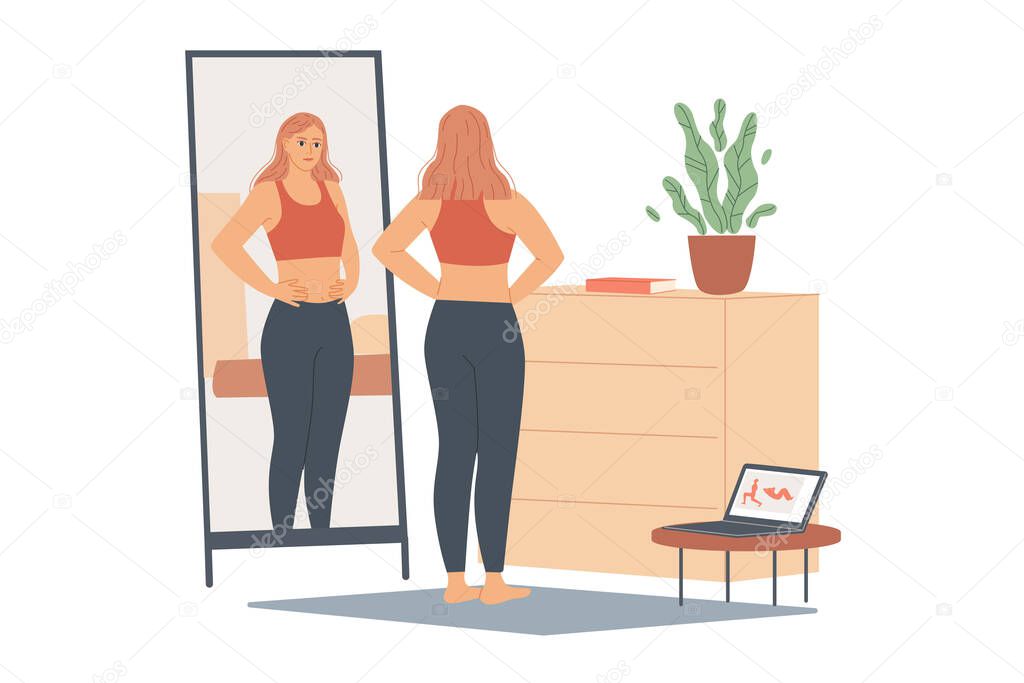 Woman not happy with her weight, she looks at her belly and waist, stands in front of a mirror and looks at her body after training.