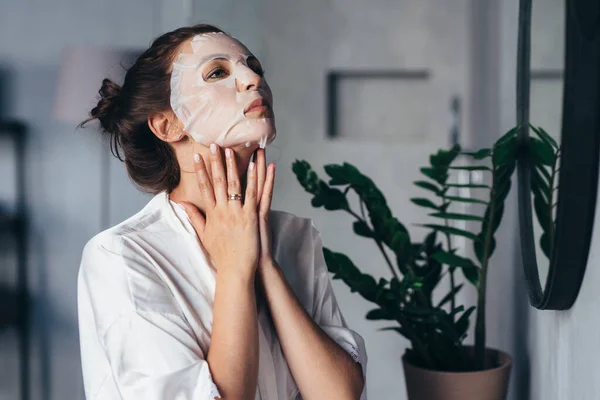 Mulher faz tratamentos de rejuvenescimento facial em casa — Fotografia de Stock