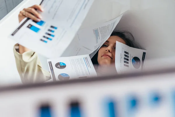 A lot of work fell on the woman, documents cover her body — Stock Photo, Image