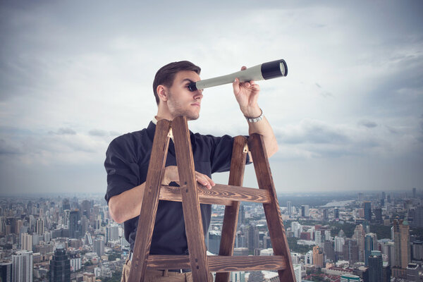 Young businessman looking for future opportunities through the spyglass standing on stairs.  Cloudy sky and city around