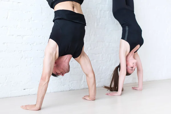 Sporters vrouw en man doen een handstand tegen muur kant bekijken concept sport fitness lifestyle mensen. — Stockfoto