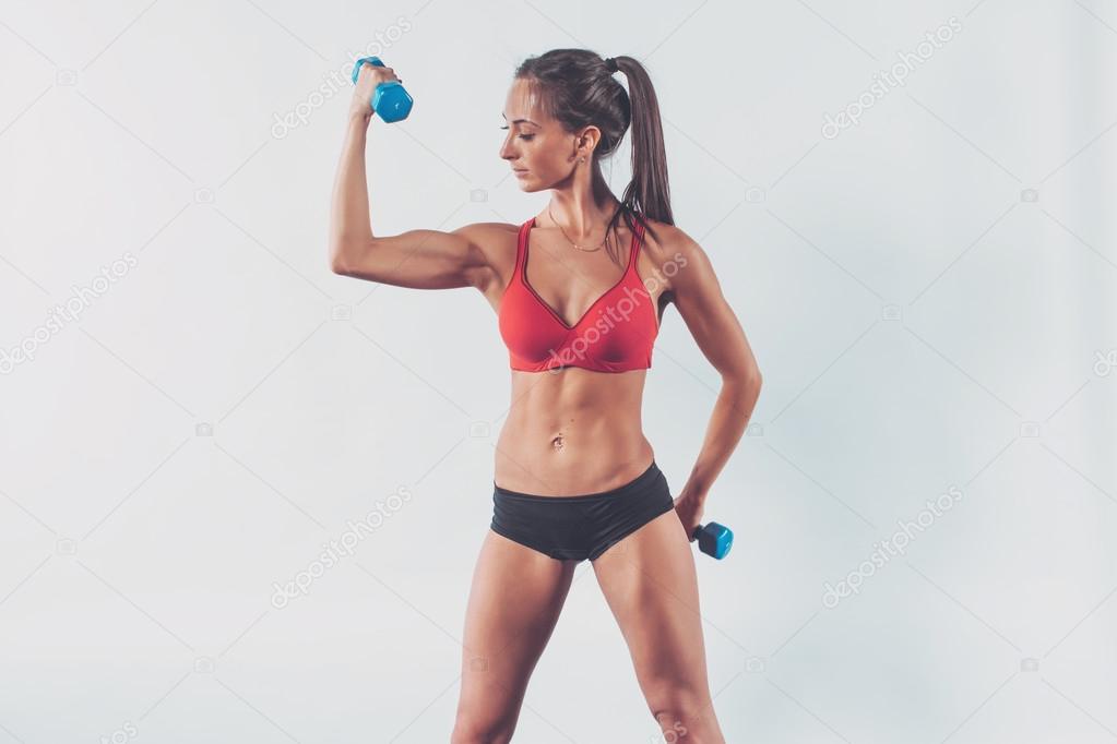 athletic woman pumping biceps doing workout lifting up dumbbell exercise for arm muscles fitness, sport, training diet lifestyle concept