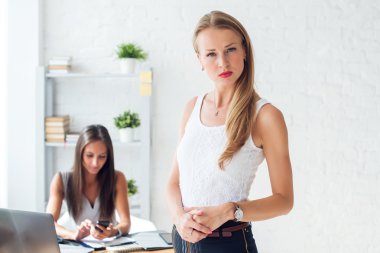 Portait of beautiful successful business woman looking confident and serious.